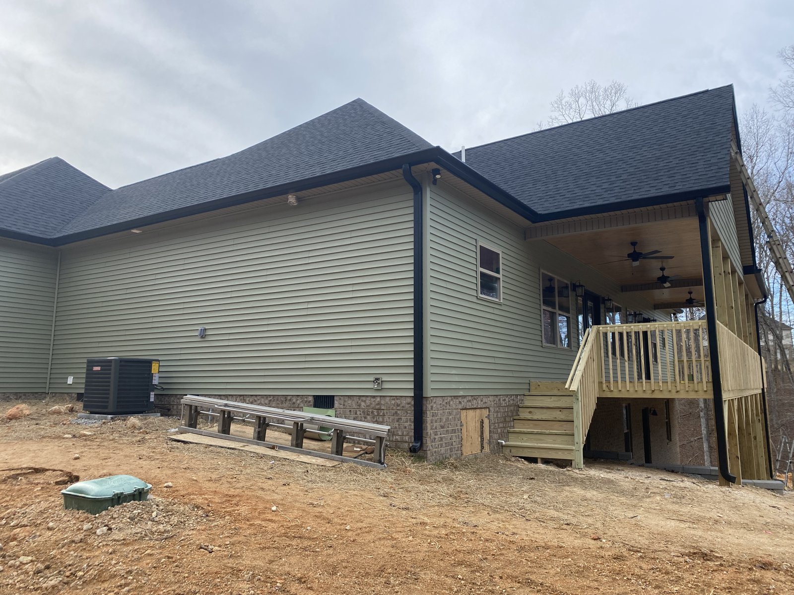 White modern farmhouse with covered porch and seamless gutters in Chickamauga, GA