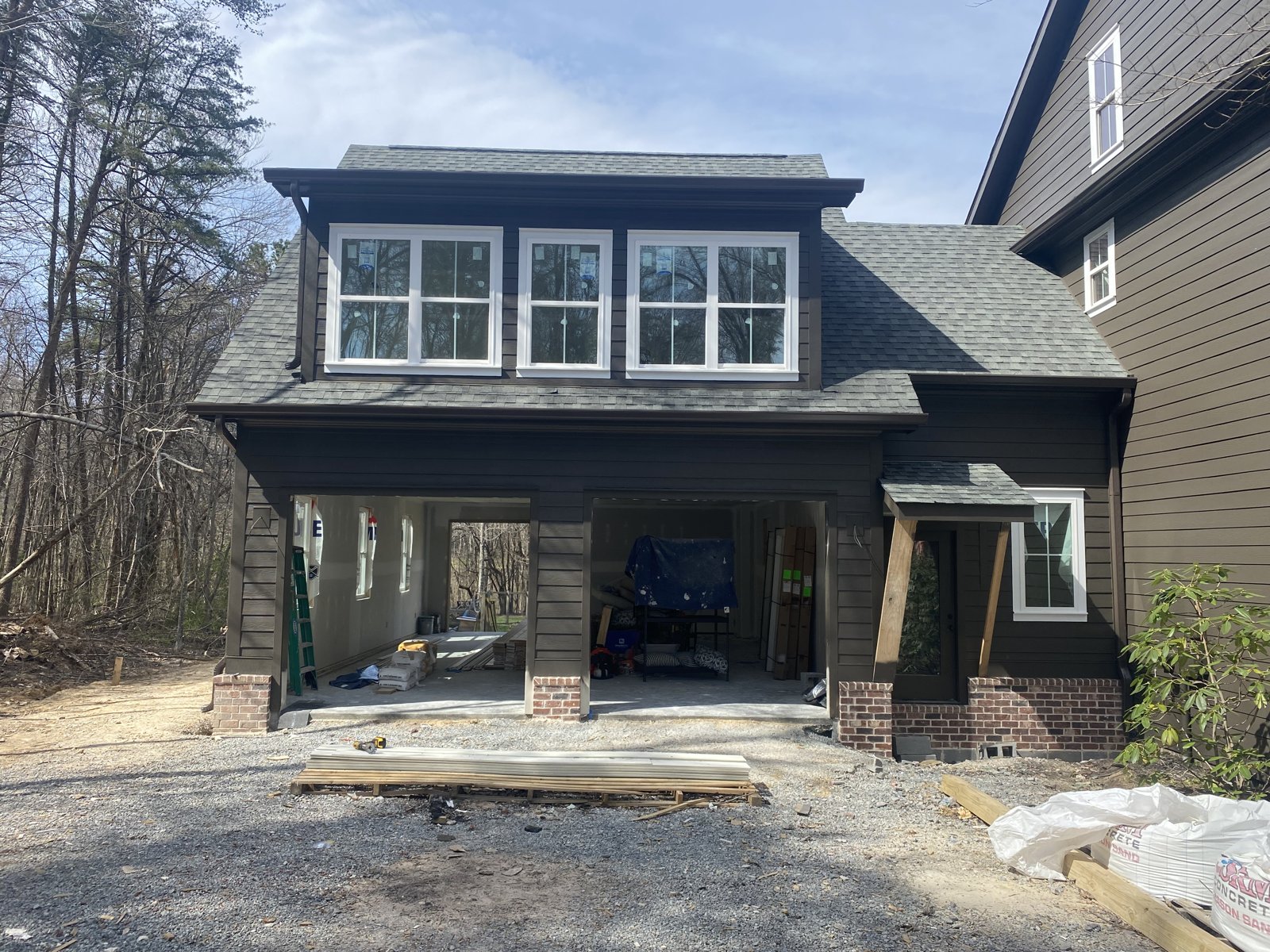 White board-and-batten home with covered porch and seamless gutters in East Brainerd, TN