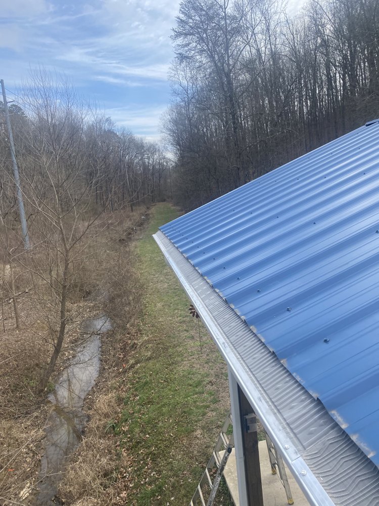 White siding home corner with new dark gutter detail in Hixson, TN