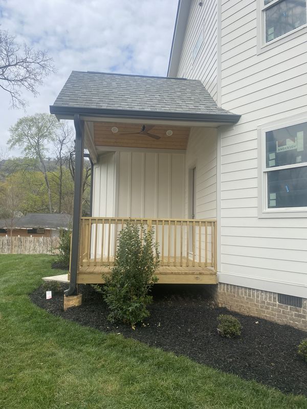 New porch addition with custom-fit dark gutter run