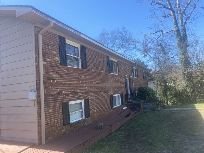 Two-story brick home gutter installation