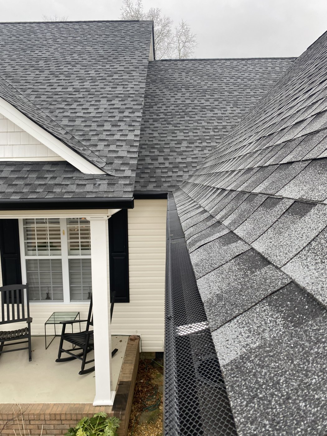 Leaf guards installed along a roofline gutter run