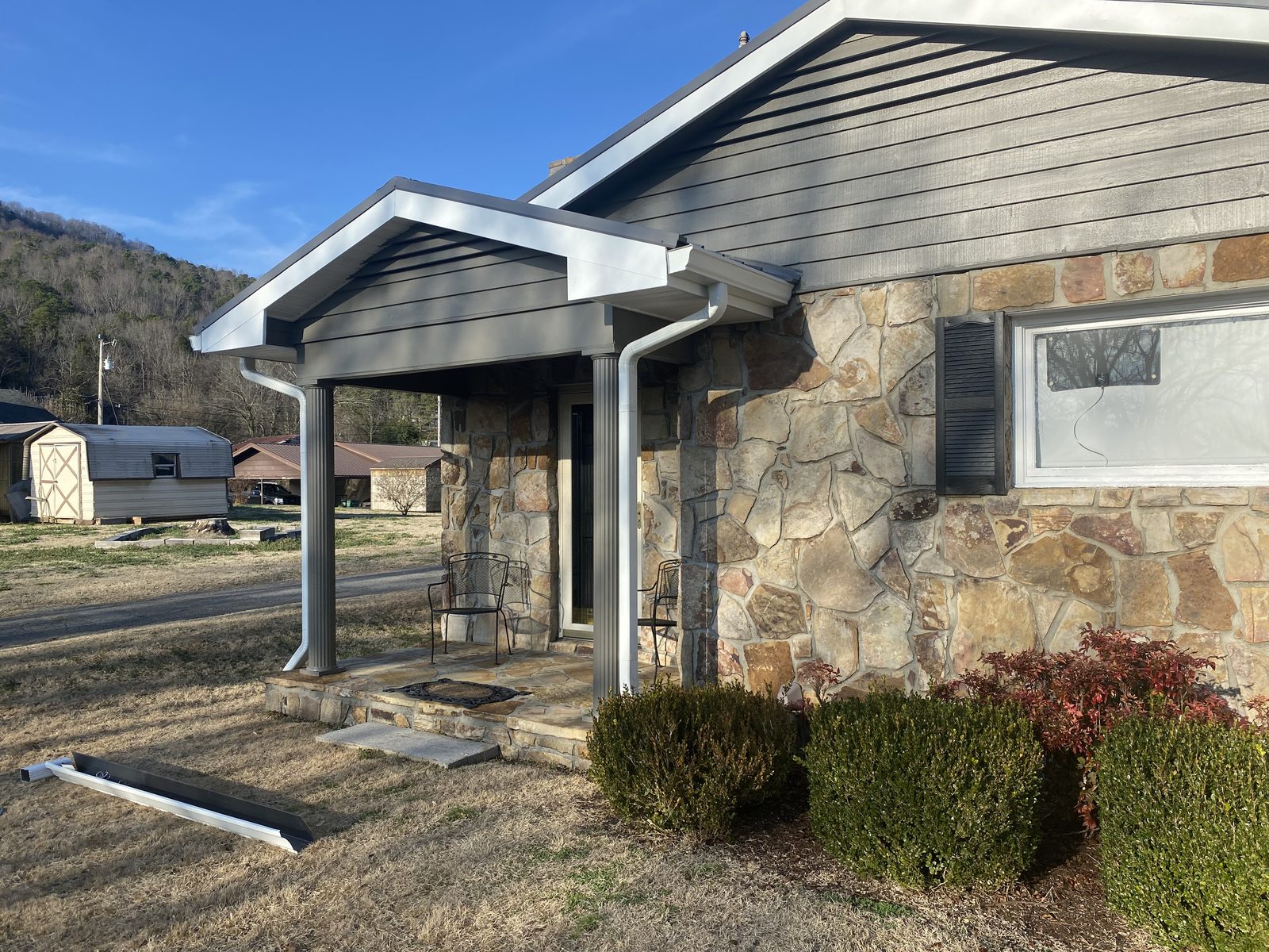 Stone-front Chattanooga home with new seamless gutters installed by Riverbend Gutter Company