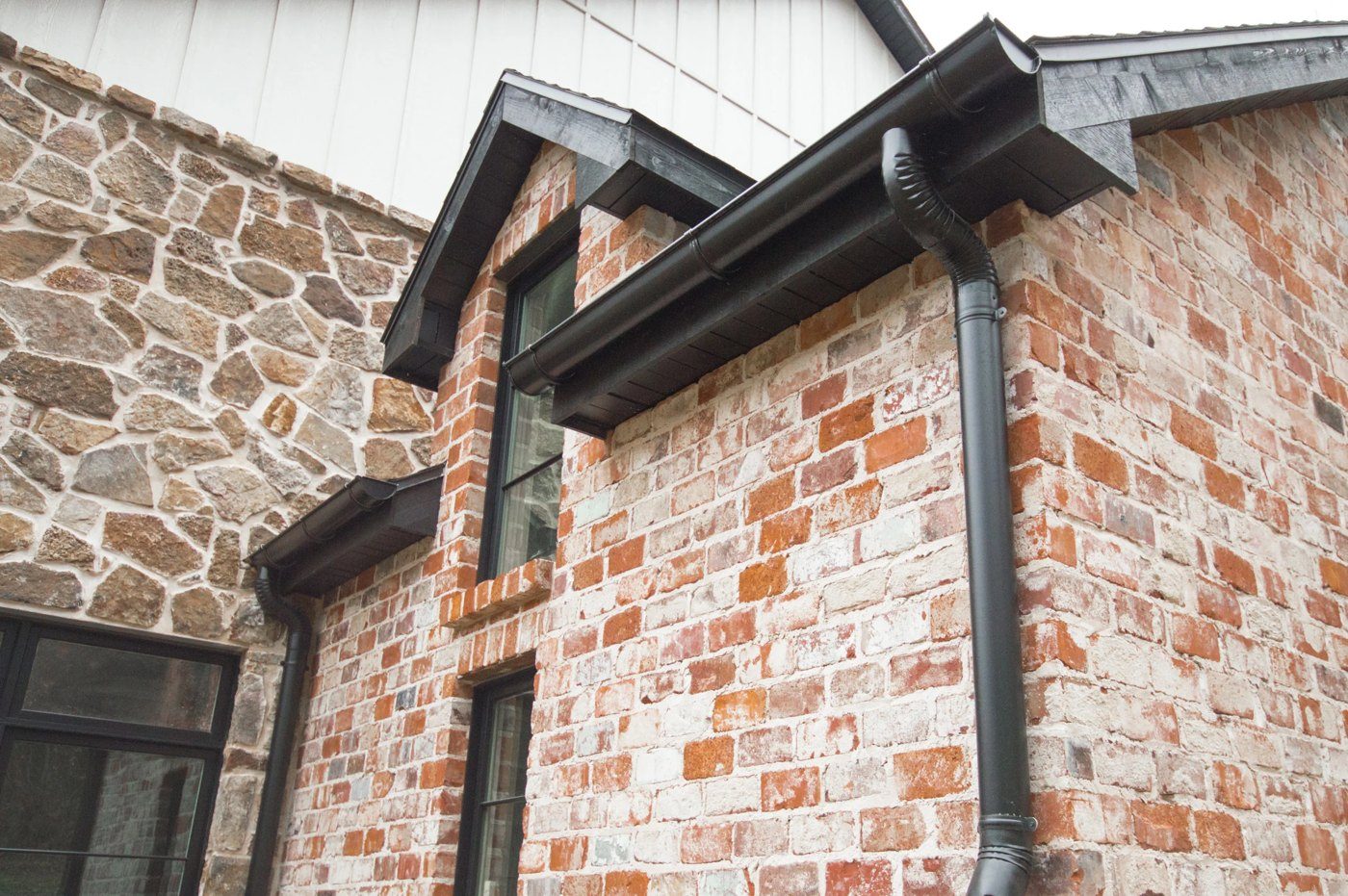 Close-up of a downspout and drainage outlet on a home
