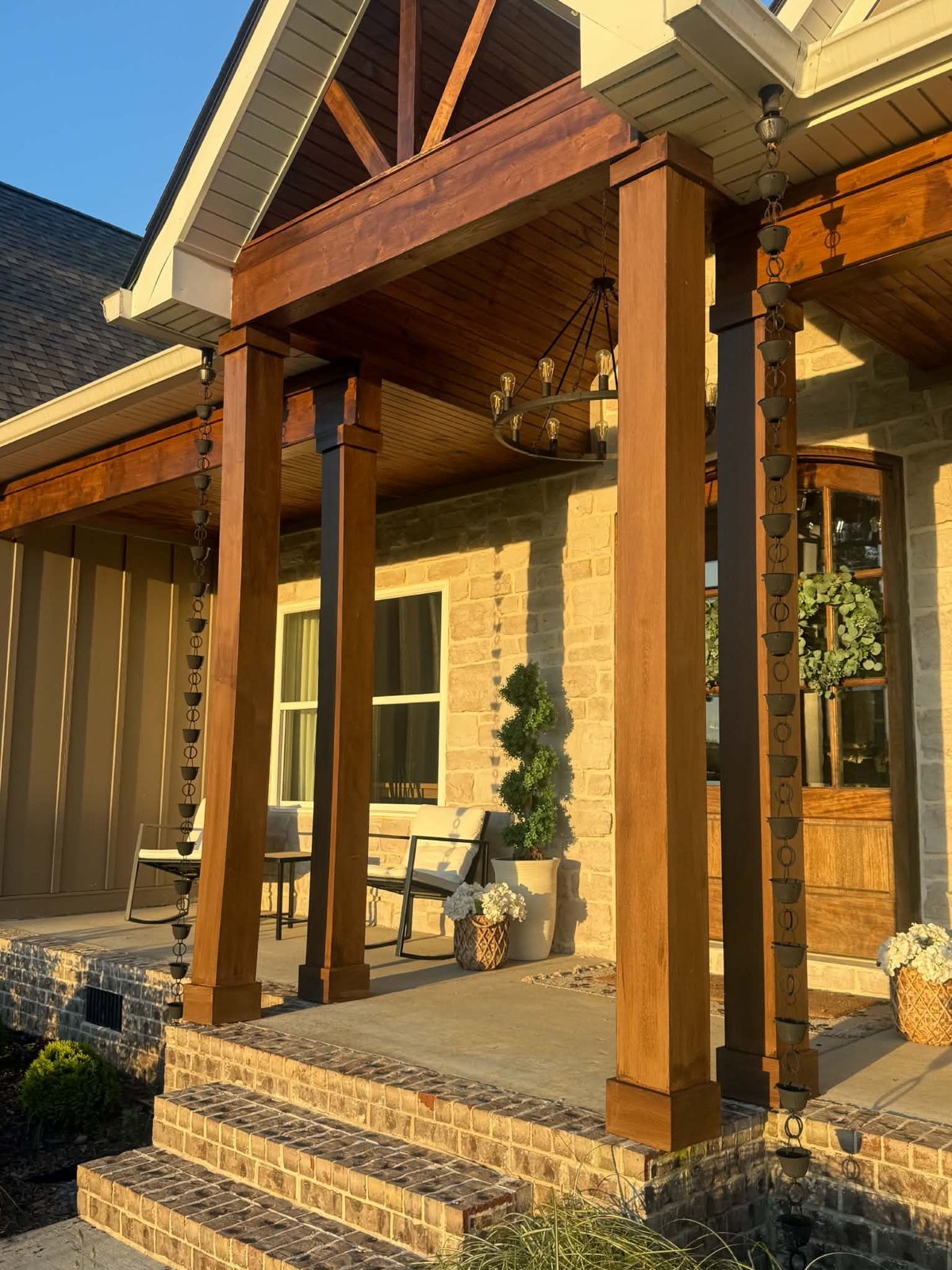 Rain chain downspout on a covered porch installed by Riverbend Gutter Company