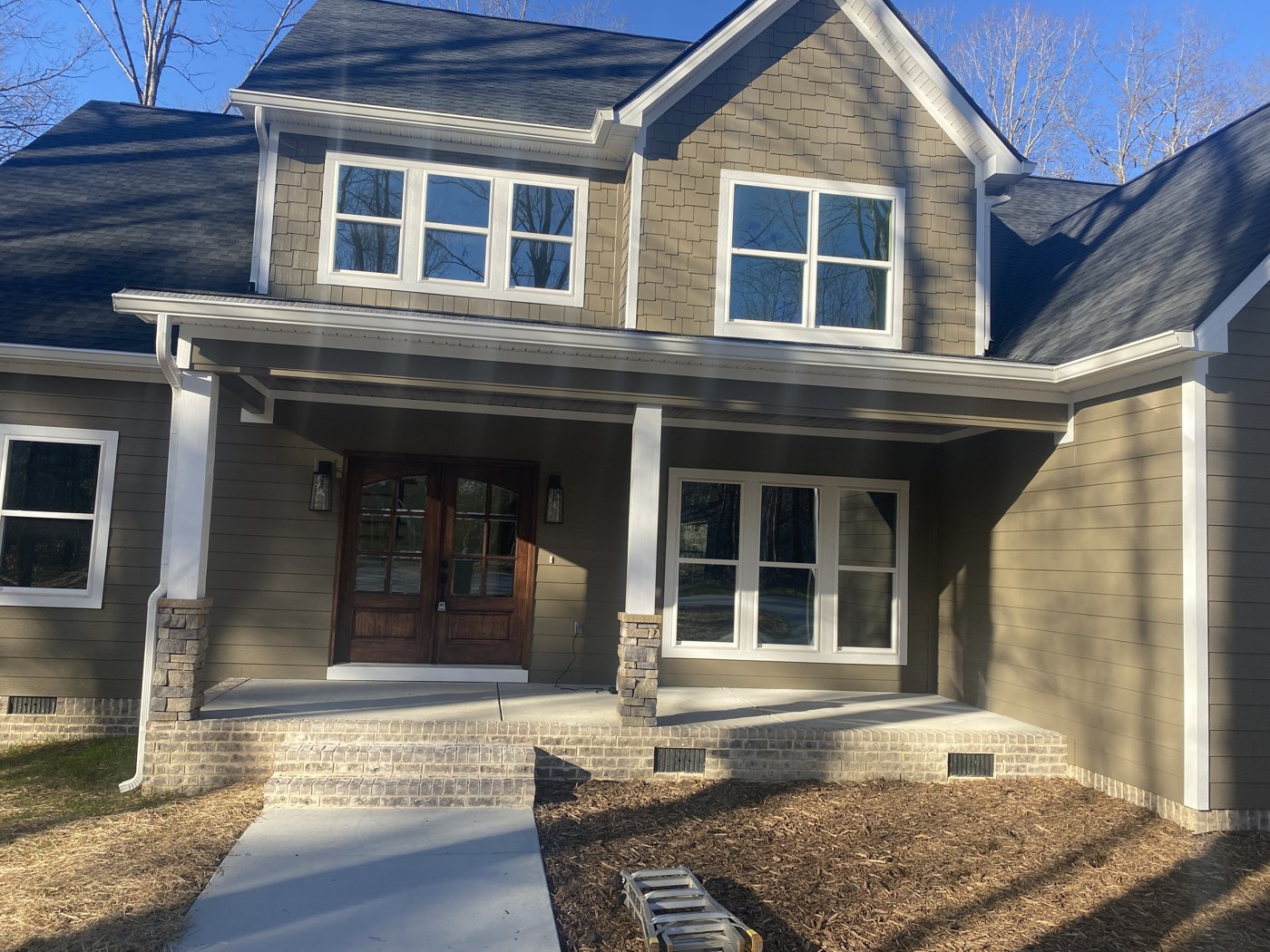 Two-story home with seamless gutters in a custom color