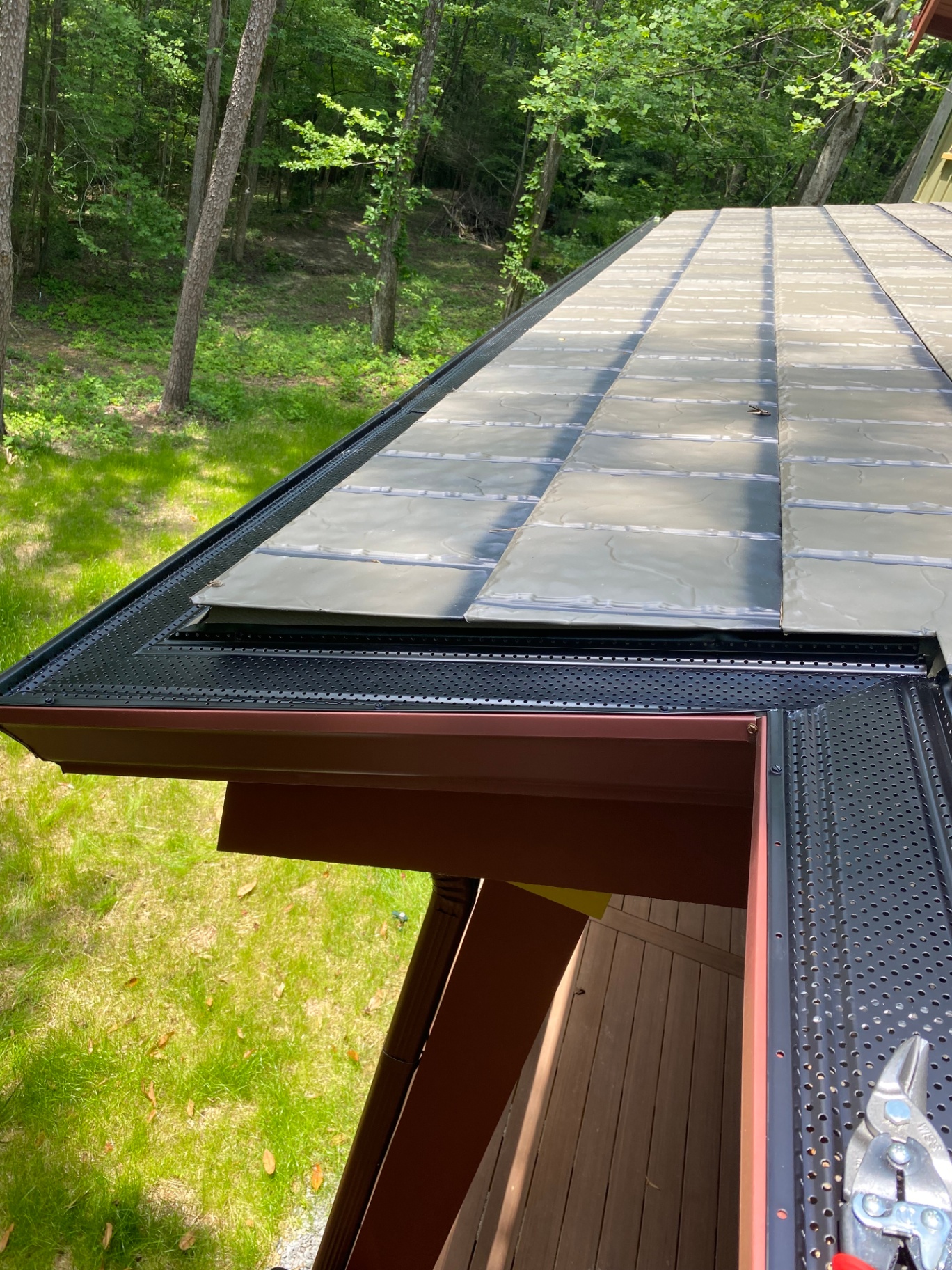 Professional gutter guard system with metal roofing protection